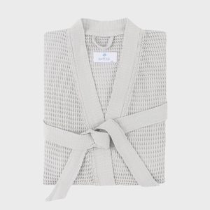 A folded, textured bathrobe is neatly tied, displayed on a plain background. Label reads â€œMATOUK S/M.â€