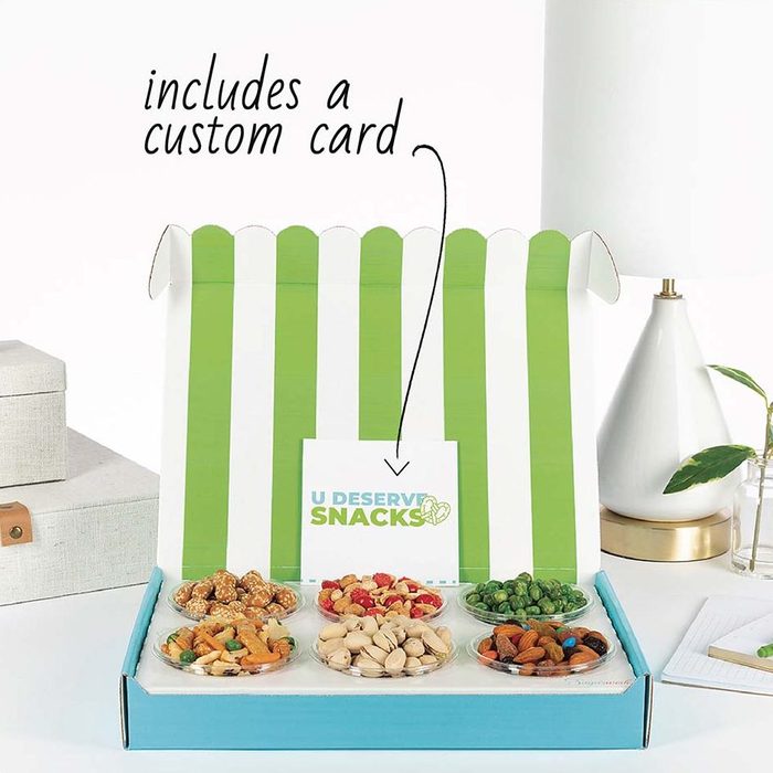 Open snack box displaying various nuts and snacks, with a card reading 