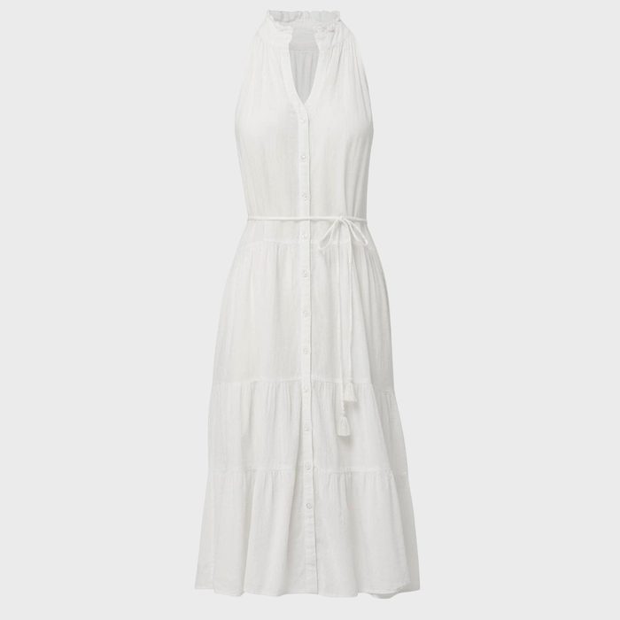 White sleeveless dress hangs against plain background, featuring a button-down front and a tied waist belt.