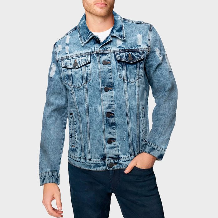 Denim jacket worn by a person standing casually; slightly distressed with visible buttons and pockets, against a plain background.