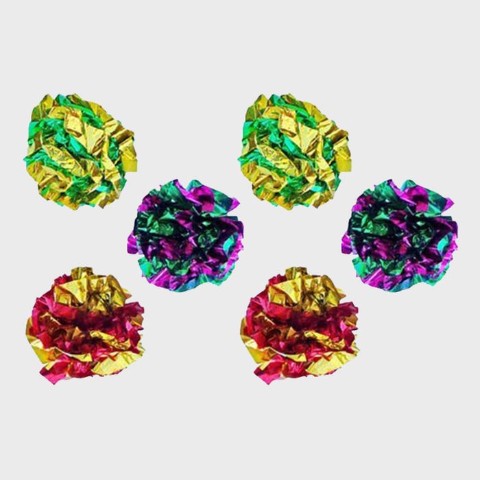 Colorful crumpled foil balls are arranged, showcasing shiny multicolored surfaces, set against a plain white background.