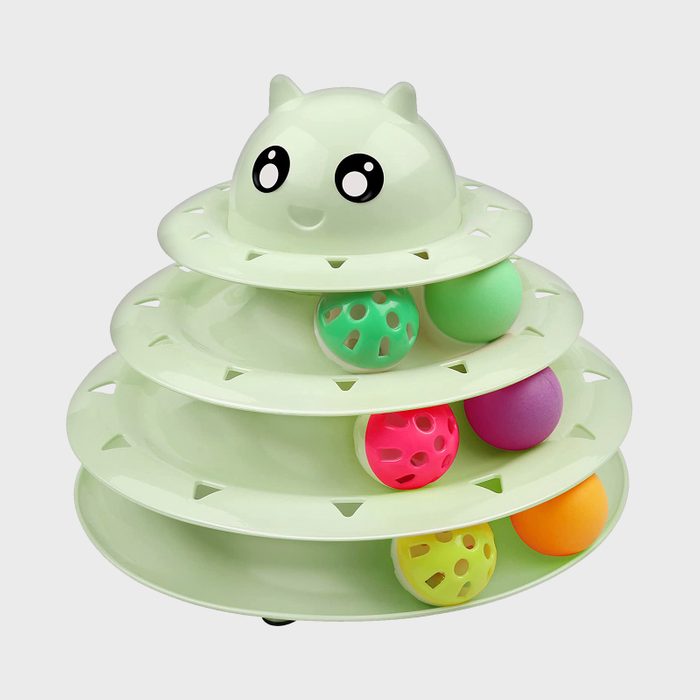 Tiered green cat toy with wide eyes, featuring colorful balls rolling in circular tracks, against a plain white background.