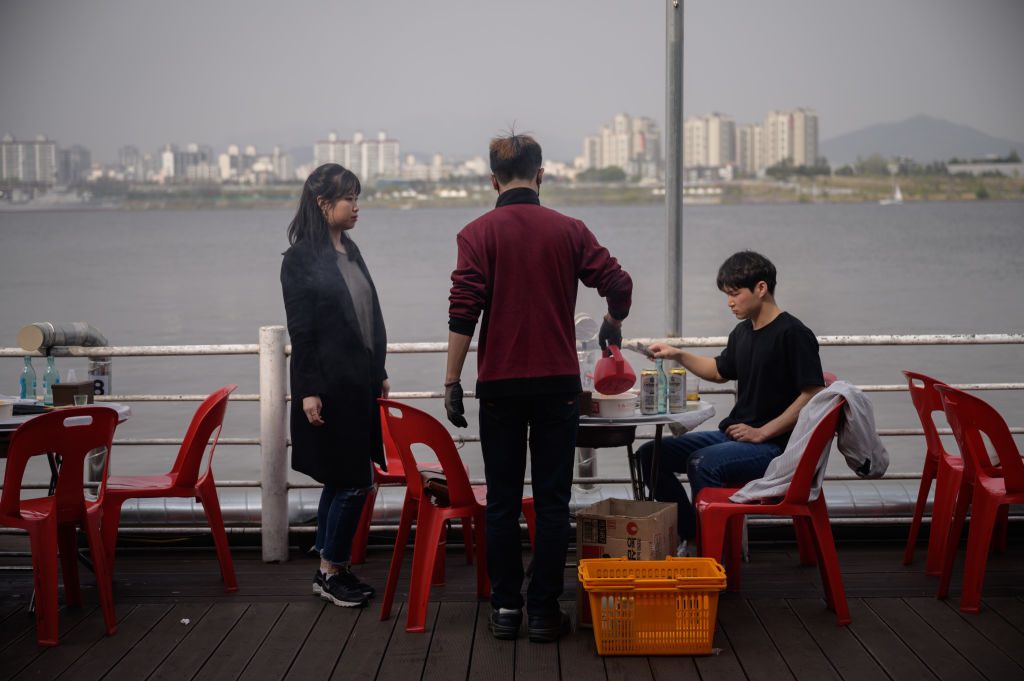 waiter serving customers in south korea restaurant