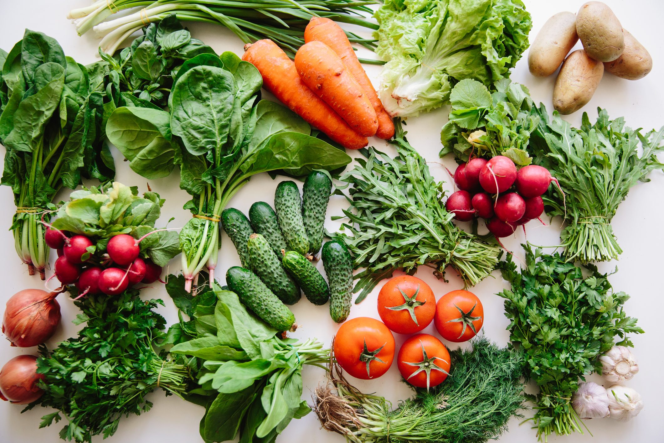 Fresh greens and vegetables on a table, high angle view