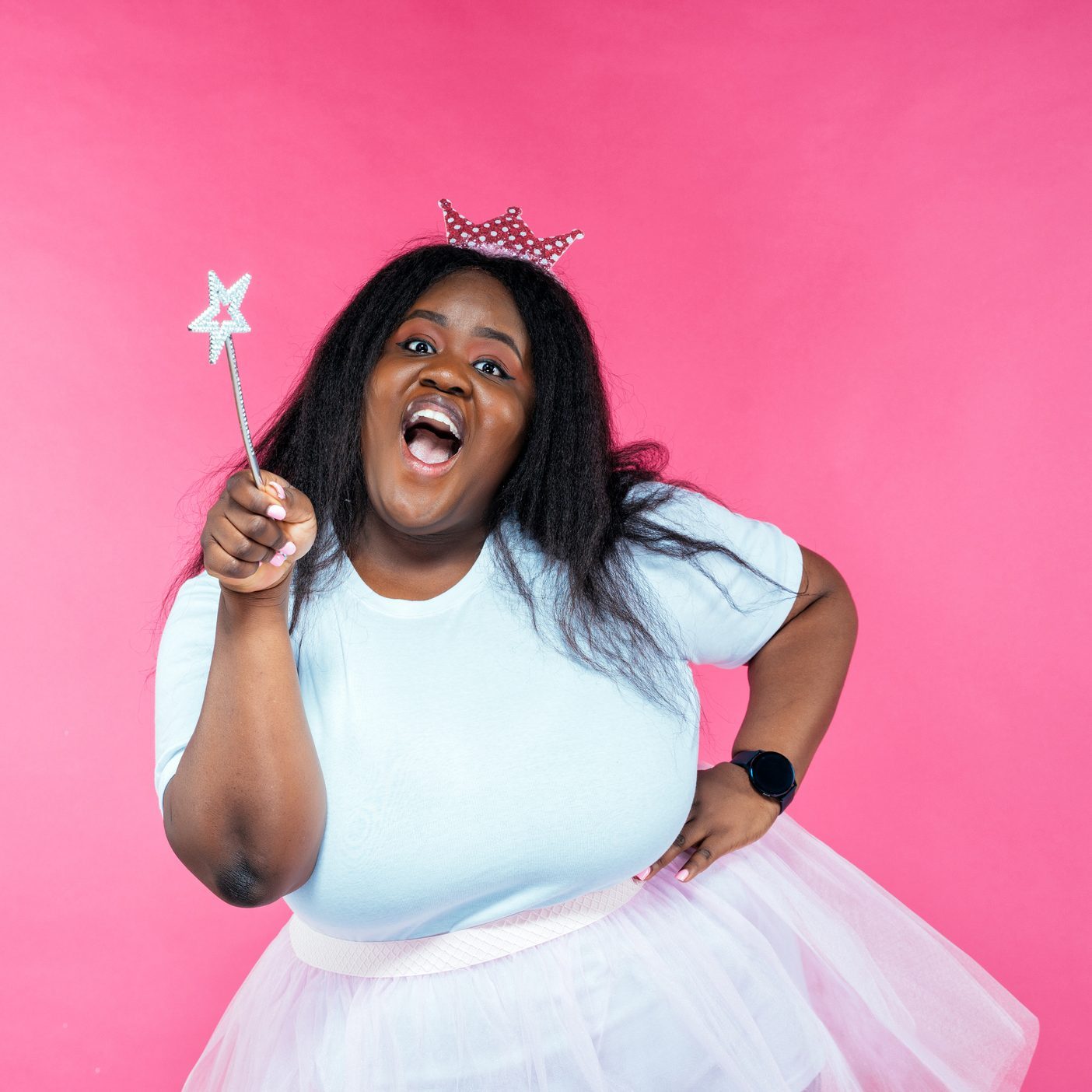 Image of a beautiful woman posing in a fairy costume on a pink background