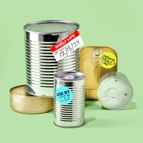 Cans with labels show expiration dates, including 