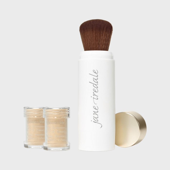 Brush standing next to two small powder containers, with text 