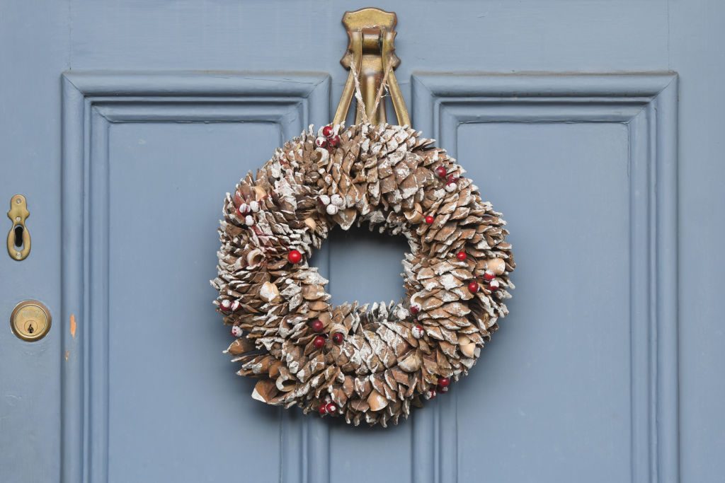 Christmas wreath made of pinecones on a blue front door in dublin