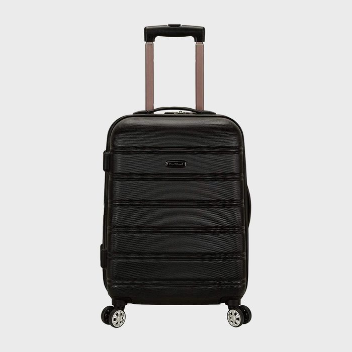 A black wheeled suitcase stands upright on a plain background; its telescopic handle is extended for pulling.
