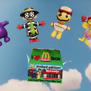 Four cartoon figures float above a green box against a cloudy sky. Text: 
