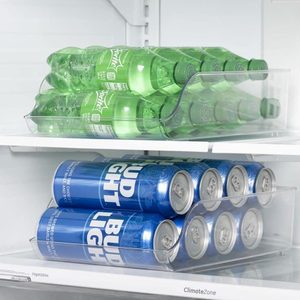 Beverage cans and bottles sit in a clear organizer inside a refrigerator, with 