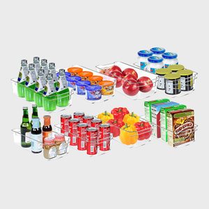 Clear plastic bins hold drinks, yogurt, apples, cans, peppers, and cereal boxes; arranged in an organized manner on a white background.