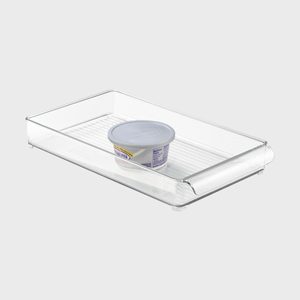 A transparent tray holds a packaged block of cheddar cheese, displayed on a plain, light background.