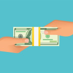 Two hands exchange a stack of dollar bills against a plain turquoise background.