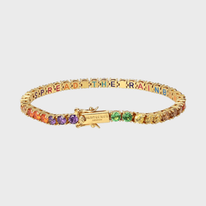 A gold bracelet displays colorful gemstones with text 