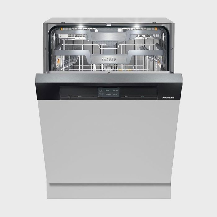 Dishwasher door open, revealing clean interior with racks, lights illuminating. Placed in a minimalistic kitchen setting. Brand name 