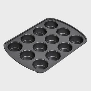 Muffin tray with twelve cups, angled view, on a plain light gray background.