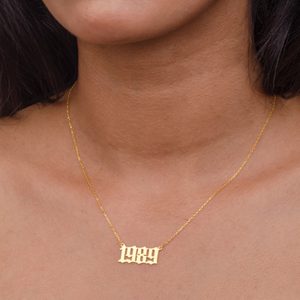 Gold necklace features pendant with 