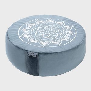 Round cushion displaying an intricate mandala design sits on a gray background. A label reads 
