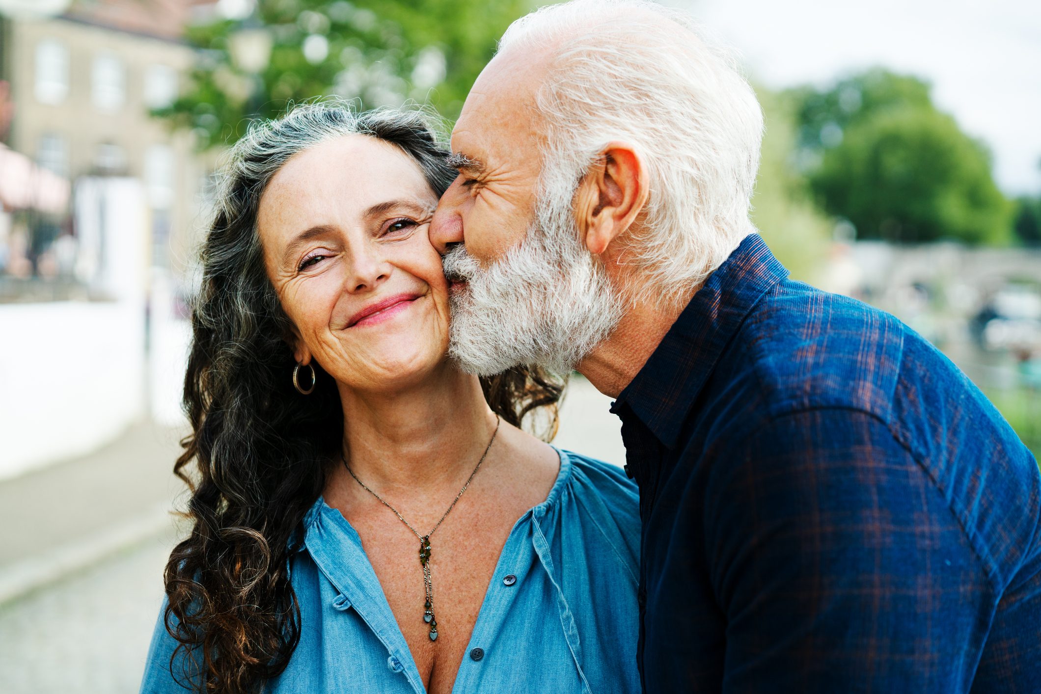 Man kissing woman partner on cheek