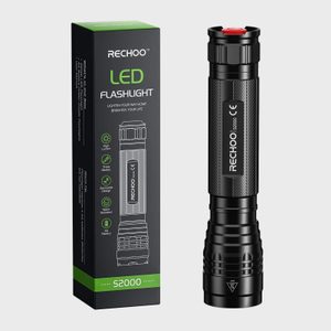Flashlight stands upright beside its box, featuring 