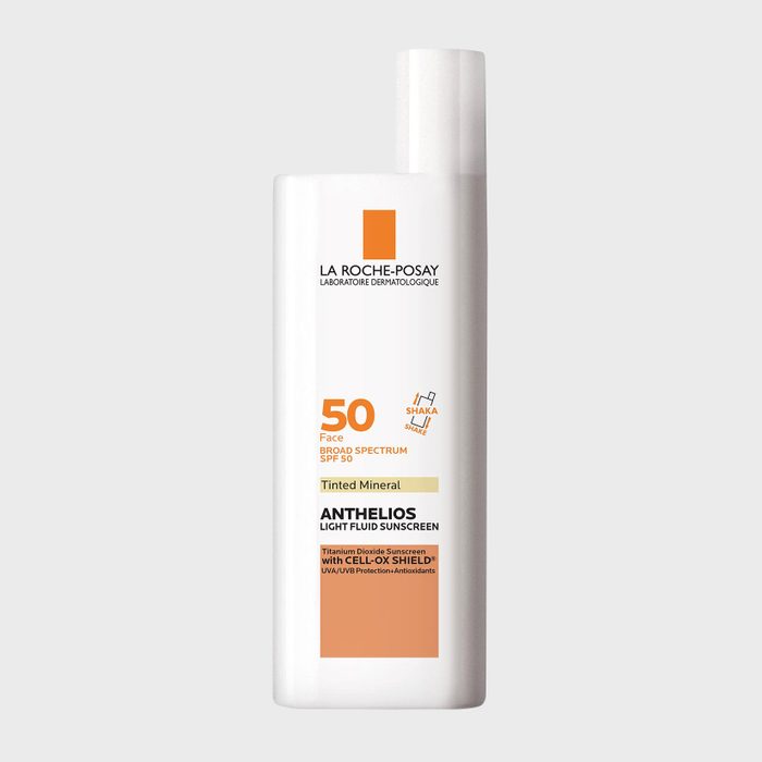 White bottle displays sunscreen details; labeled 