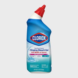 Bottle leans to the right, featuring a red nozzle. 