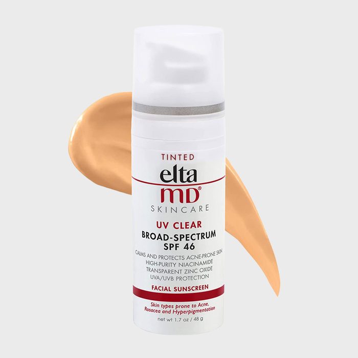 Bottle displays EltaMD tinted sunscreen, SPF 46, calming and protecting acne-prone skin, against a light beige background with a swatch nearby.