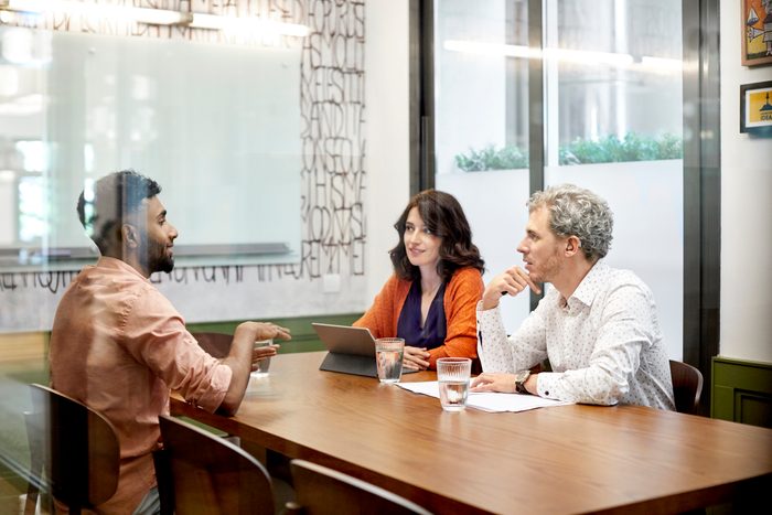 Colleagues discussing in meeting at office