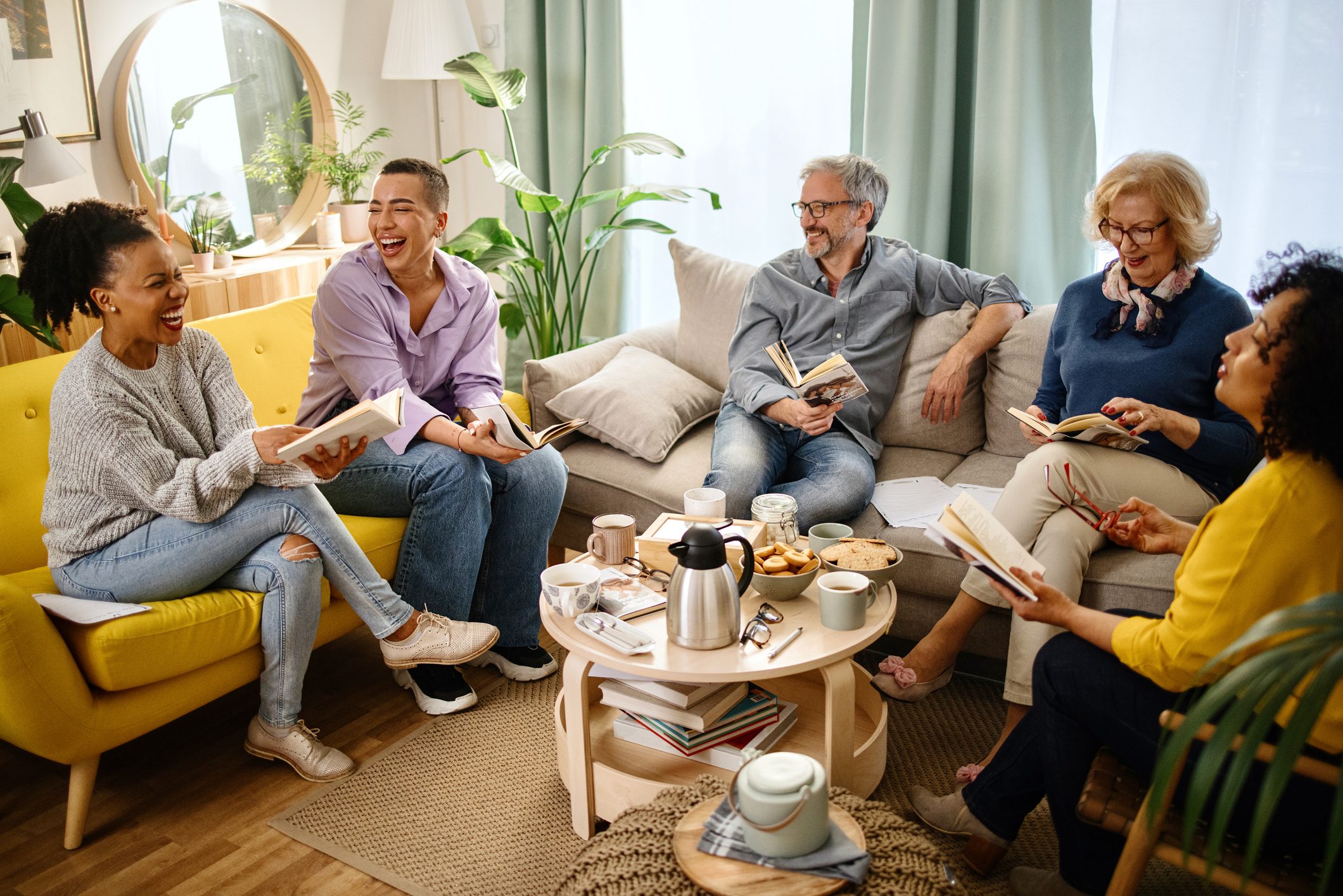 Friends at a Book Club discussing a book together and laughing