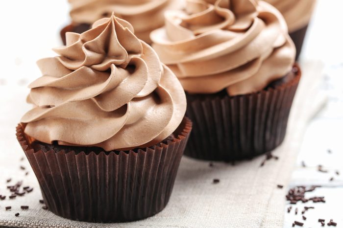 Tasty cupcakes on a white wooden table