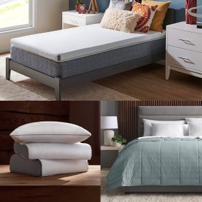 Mattress topped with white cover, adorned with colorful pillows in a cozy bedroom; stacked pillows rest on wooden surface; bed with teal blanket in modern room.