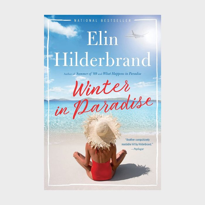 A woman in a red swimsuit relaxes on a sunny beach, facing turquoise ocean waves. Text: 