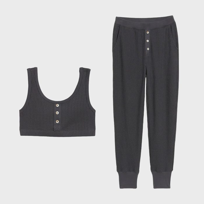 Dark gray ribbed top and pants with buttons; resting on a plain white background.