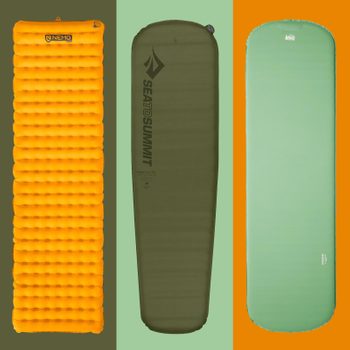 Three camping sleeping pads stand upright; left is orange, center is dark green, right is light green. Each pad features brand text.