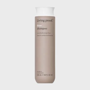 A cylindrical shampoo bottle stands upright against a plain background, displaying text: 