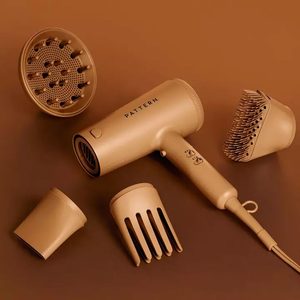 Hair dryer sits surrounded by four attachments; labeled 