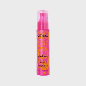 Bottle dispenses heat defense serum with pink and orange design; labeled 