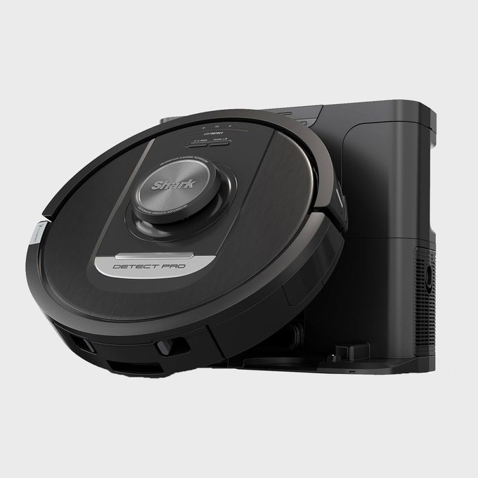 Robot vacuum docked against a base, labeled 