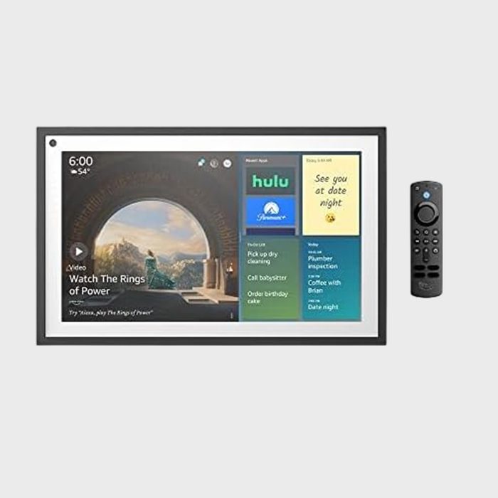 Smart display shows time, weather, video, and apps. Remote control on the side. Background features popular streaming service icons and reminders.