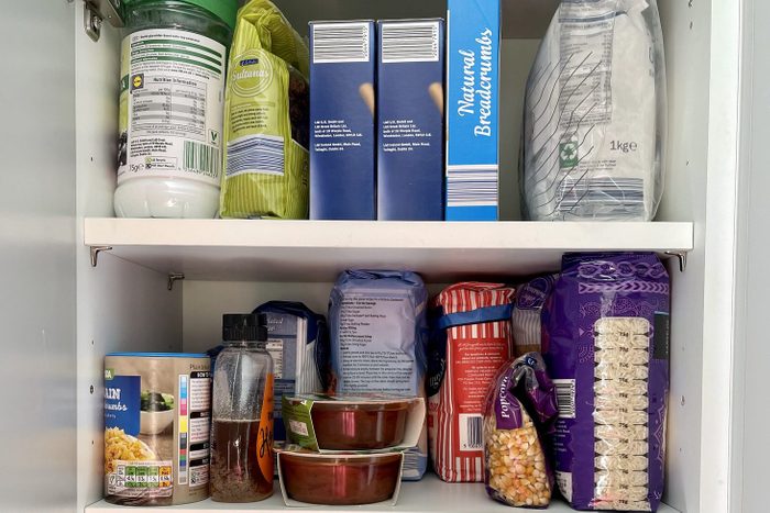 Kitchen cabinet stocked with dry food