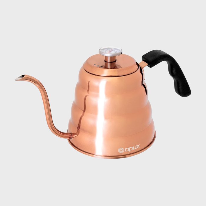 Copper kettle with a gooseneck spout and a black handle rests on a gray background; features a thermometer on the lid.