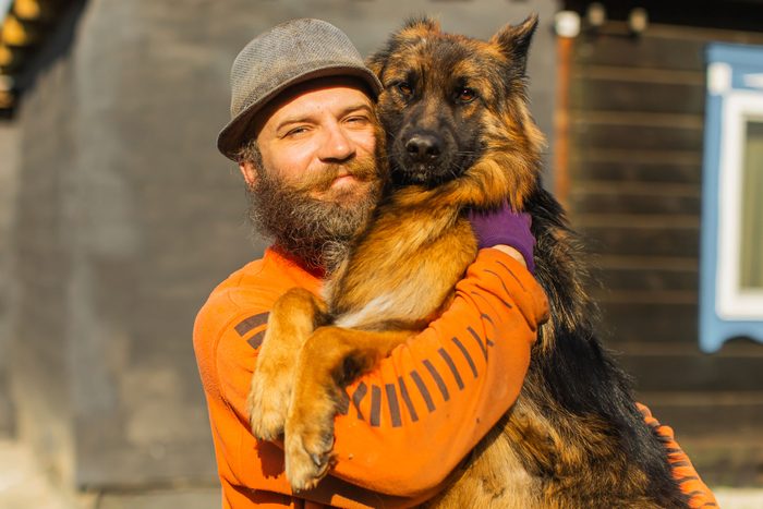 man holding a rescued dog