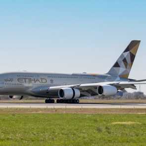 Airplane is taxiing on a runway, featuring 