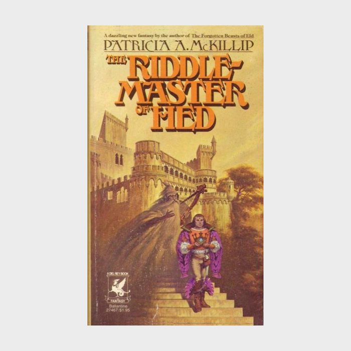 Knight stands holding a sword on castle steps, ornate castle towers behind. Text: 