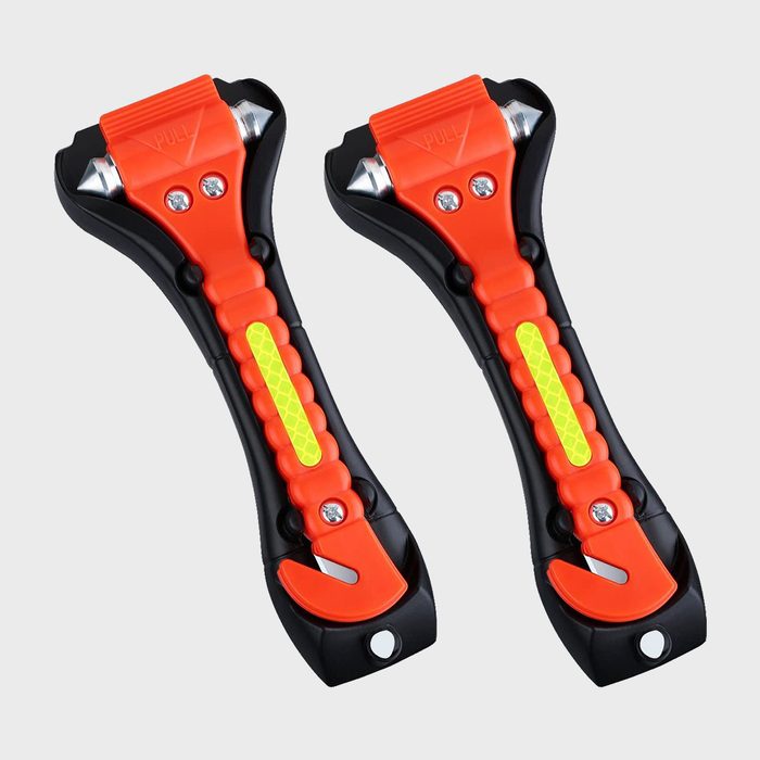 Two orange-black safety hammers with pointed metal tips and seatbelt cutters rest against a plain background.