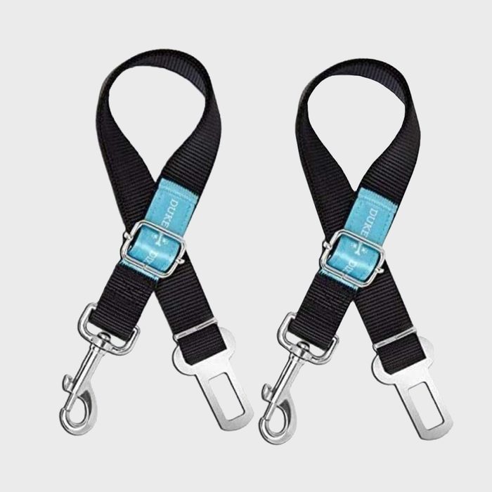 Two black seatbelt adapters lie against a plain background, featuring metal clips and buckles, with blue labels reading 