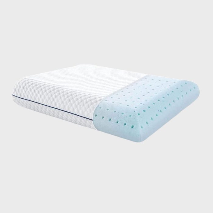 A pillow with a textured cover is partially removed, revealing a blue perforated foam interior, set against a plain white background.