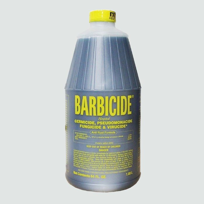Barbicidal liquid stands motionless in a ribbed, gray bottle; text details its germicidal, fungicidal function, and safety warnings against a plain background.