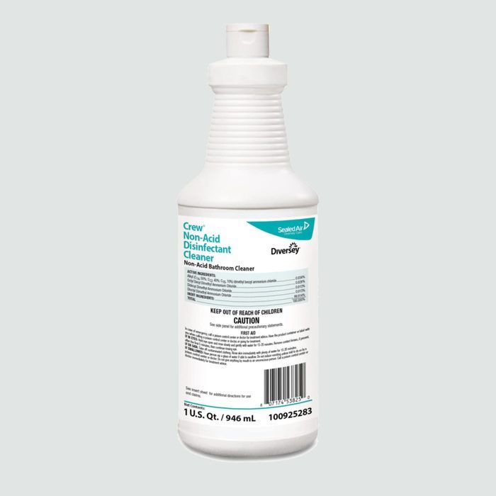 A white bottle contains Crew Non-Acid Disinfectant Cleaner, displaying details and a barcode, sitting against a pale gray background.